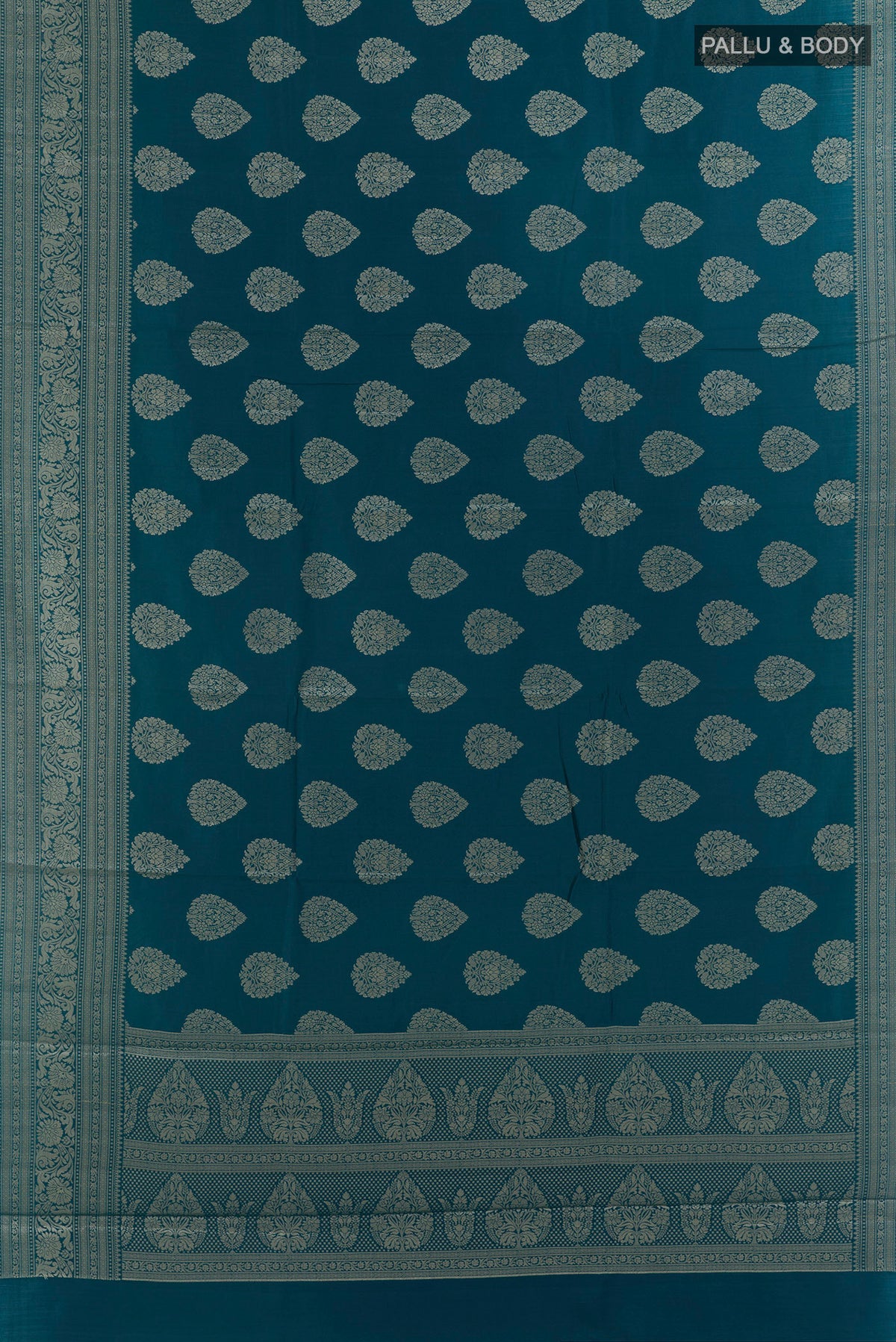 Flat view of Peacock Blue Tussar Saree with Zari Butta on the body and Zari Border. 