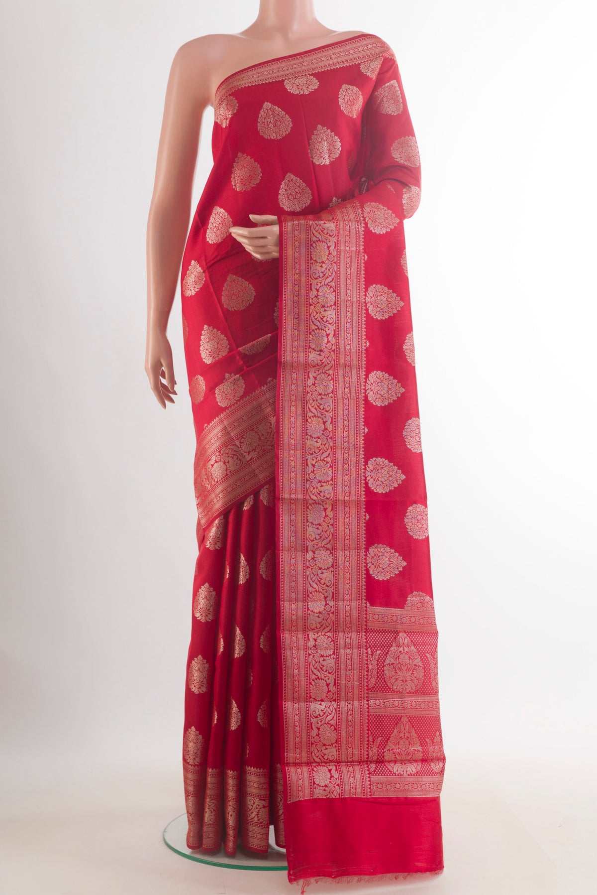 Red Tussar Saree with Zari Butta on the body and Zari Border.  displayed on a mannequin