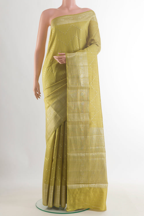 Lemon Yellow Tussar Saree with Zari Butta on the body and Zari Border.  displayed on a mannequin