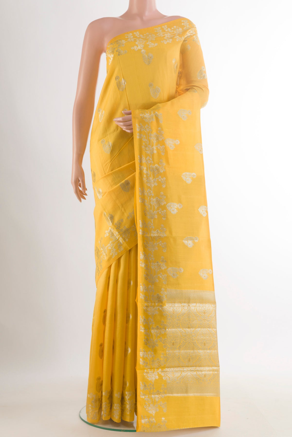 Yellow Tussar Saree with Zari Butta on the body and Zari Border.  displayed on a mannequin