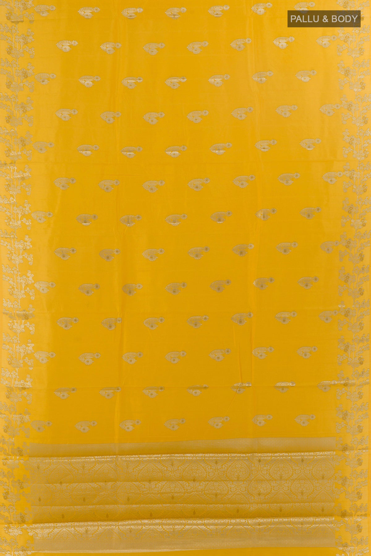 Flat view of Yellow Tussar Saree with Zari Butta on the body and Zari Border. 