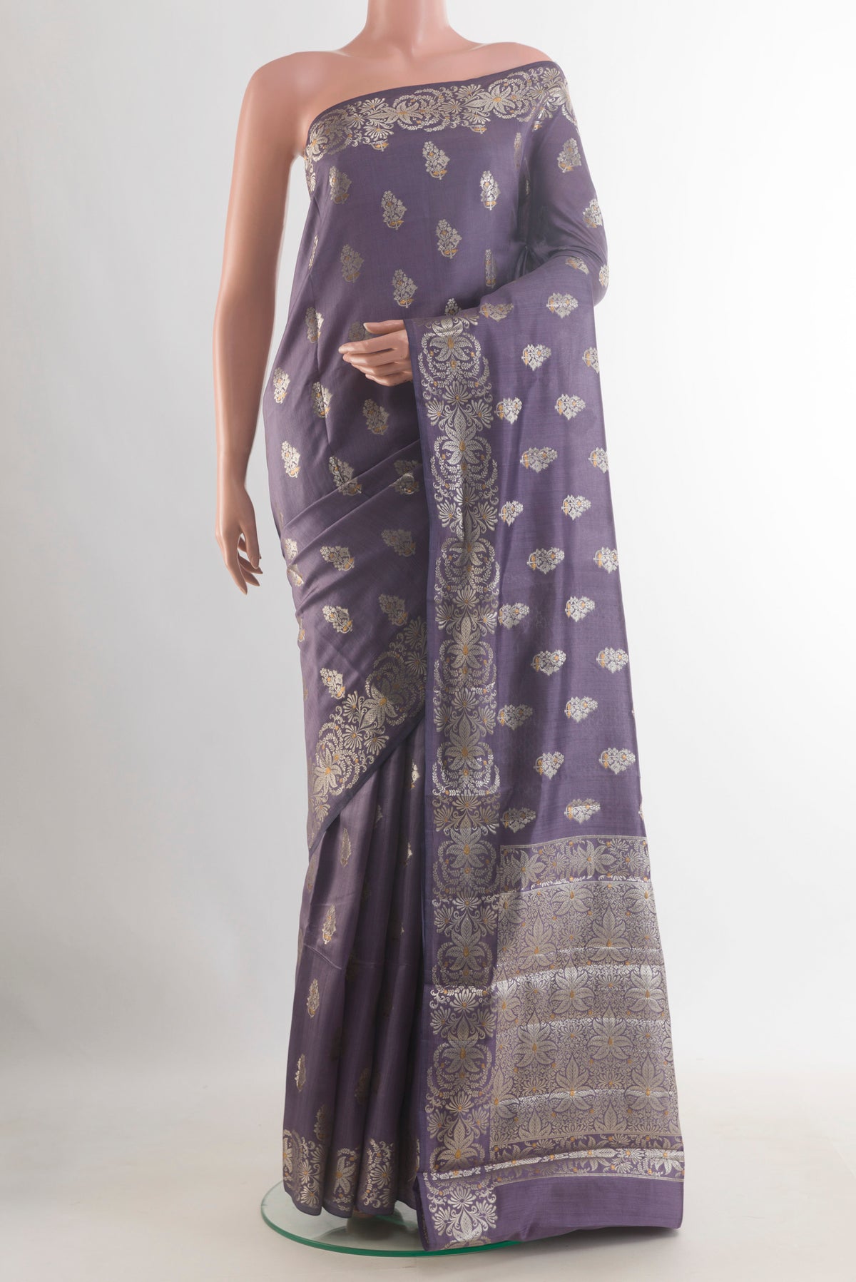 Lilac Tussar Saree with Zari Butta on the body and Zari Border.  displayed on a mannequin