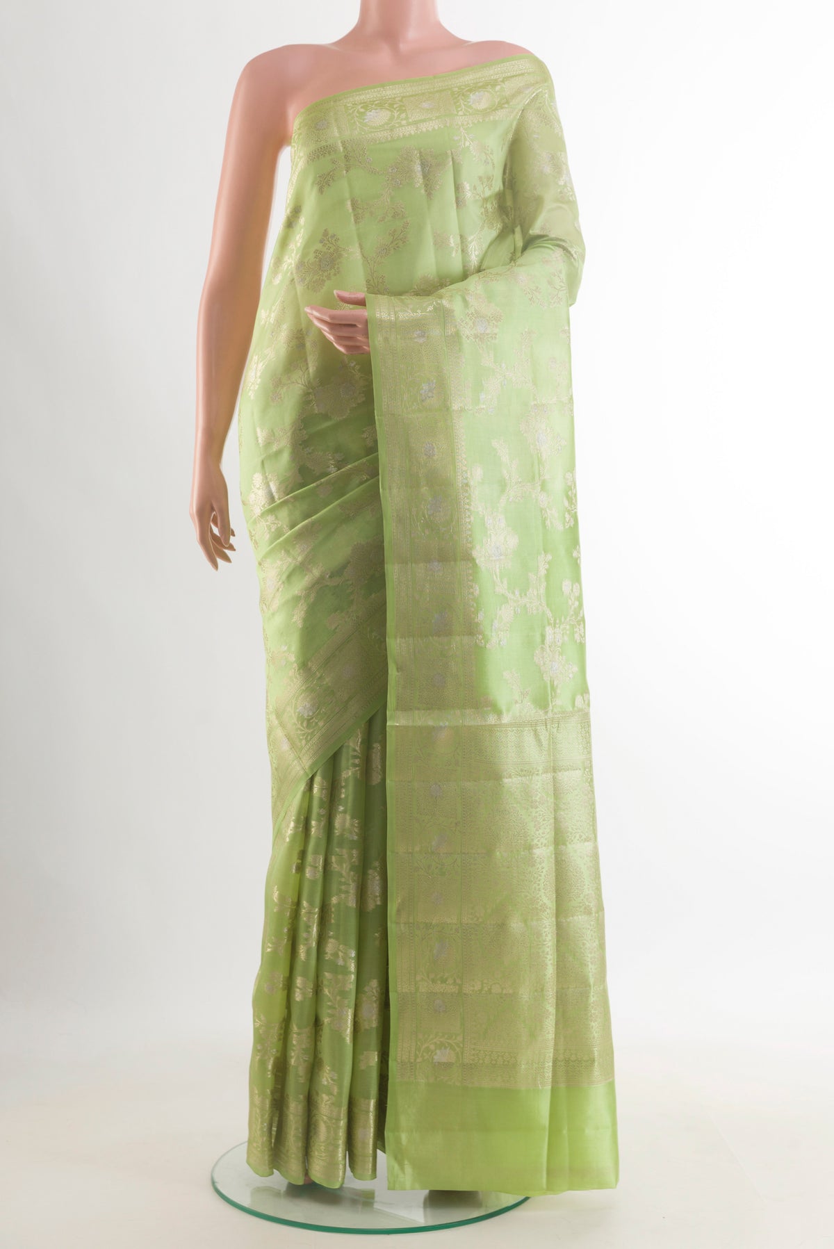 Pure Silk Green Banarasi Raw Saree with Zari Brocade on the body and Zari Border.  displayed on a mannequin