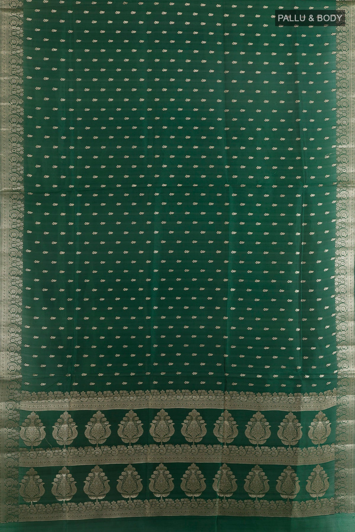 Flat view of Pure Silk Bottle Green Banarasi Raw Saree with Zari Butta on the body and Zari Border. 