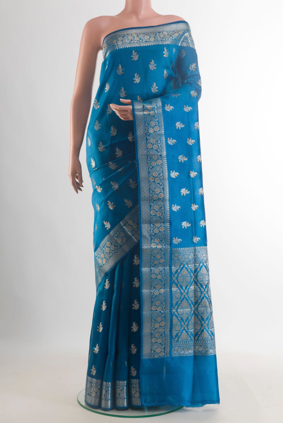 Pure Silk Blue Banarasi Raw Saree with Zari Brocade on the body and Zari Border.  displayed on a mannequin