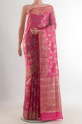Coral Banarasi Raw Saree with Zari Butta on the body and Zari Border.  displayed on a mannequin