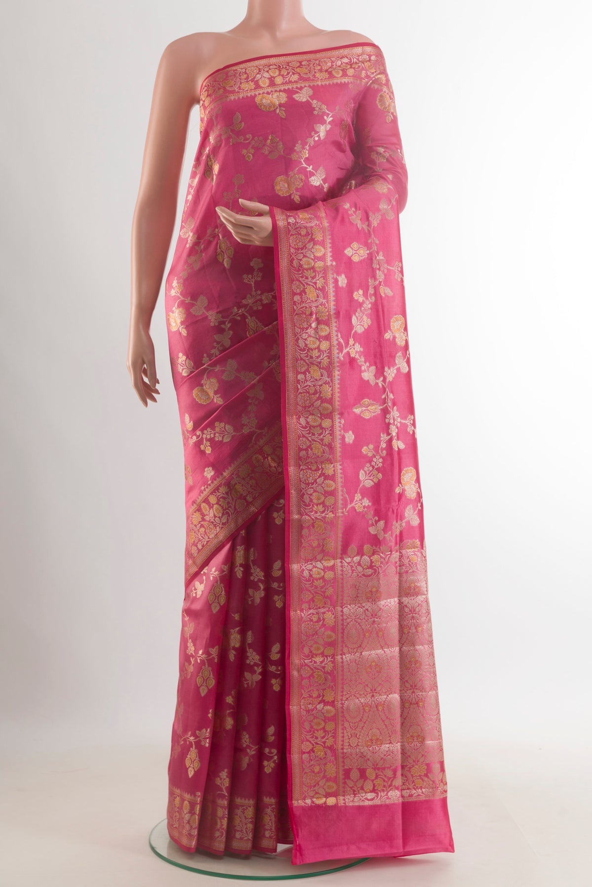 Coral Banarasi Raw Saree with Zari Butta on the body and Zari Border.  displayed on a mannequin