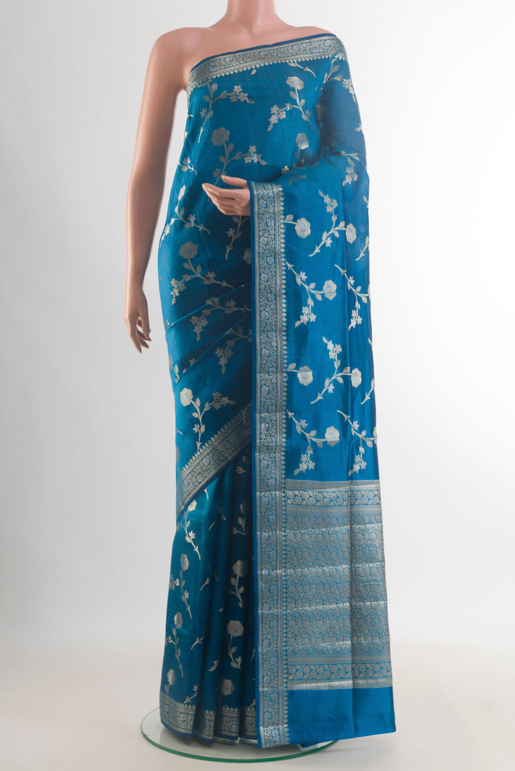 Pure Silk Blue Banarasi Raw Saree with Zari Brocade on the body and Zari Border.  displayed on a mannequin