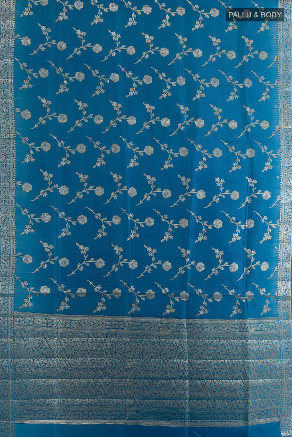 Flat view of Pure Silk Blue Banarasi Raw Saree with Zari Brocade on the body and Zari Border. 