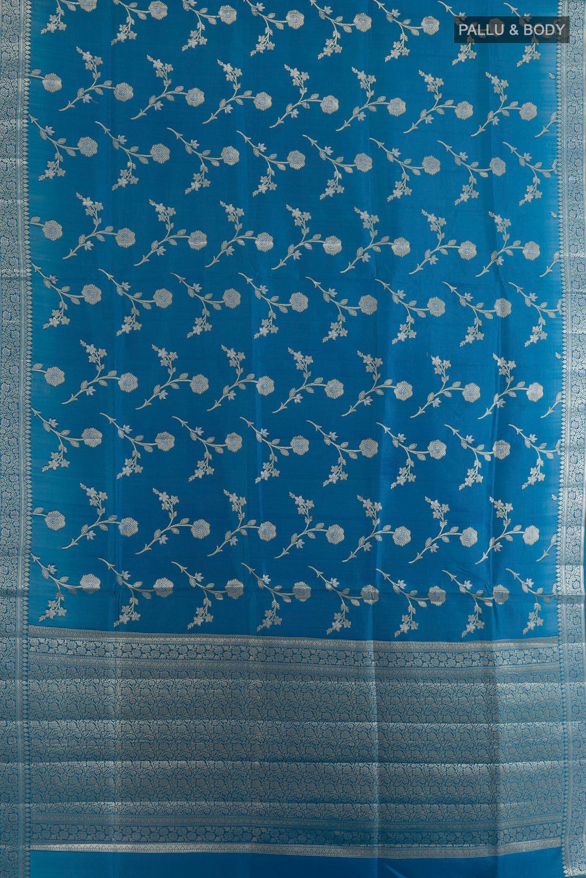 Flat view of Pure Silk Blue Banarasi Raw Saree with Zari Brocade on the body and Zari Border. 
