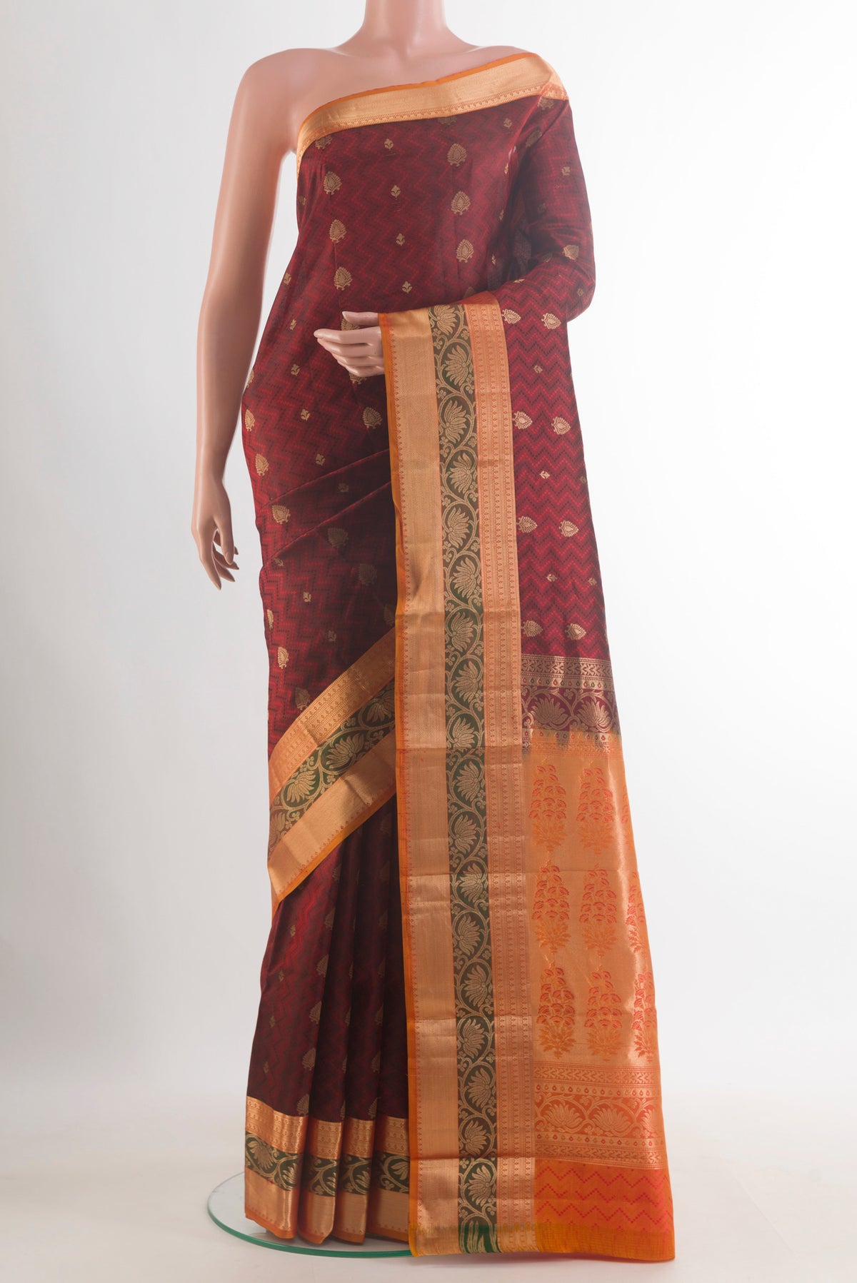 Pure Silk Maroon Kanchipuram Saree with Jacquard With Zari Butta on the body and Zari Border.  displayed on a mannequin