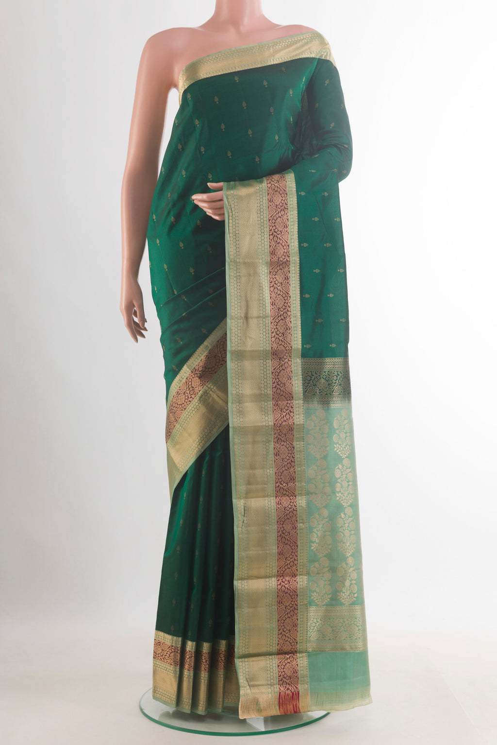 Pure Silk Bottle Green Kanchipuram Saree with Zari Butta on the body and Zari Border.  displayed on a mannequin