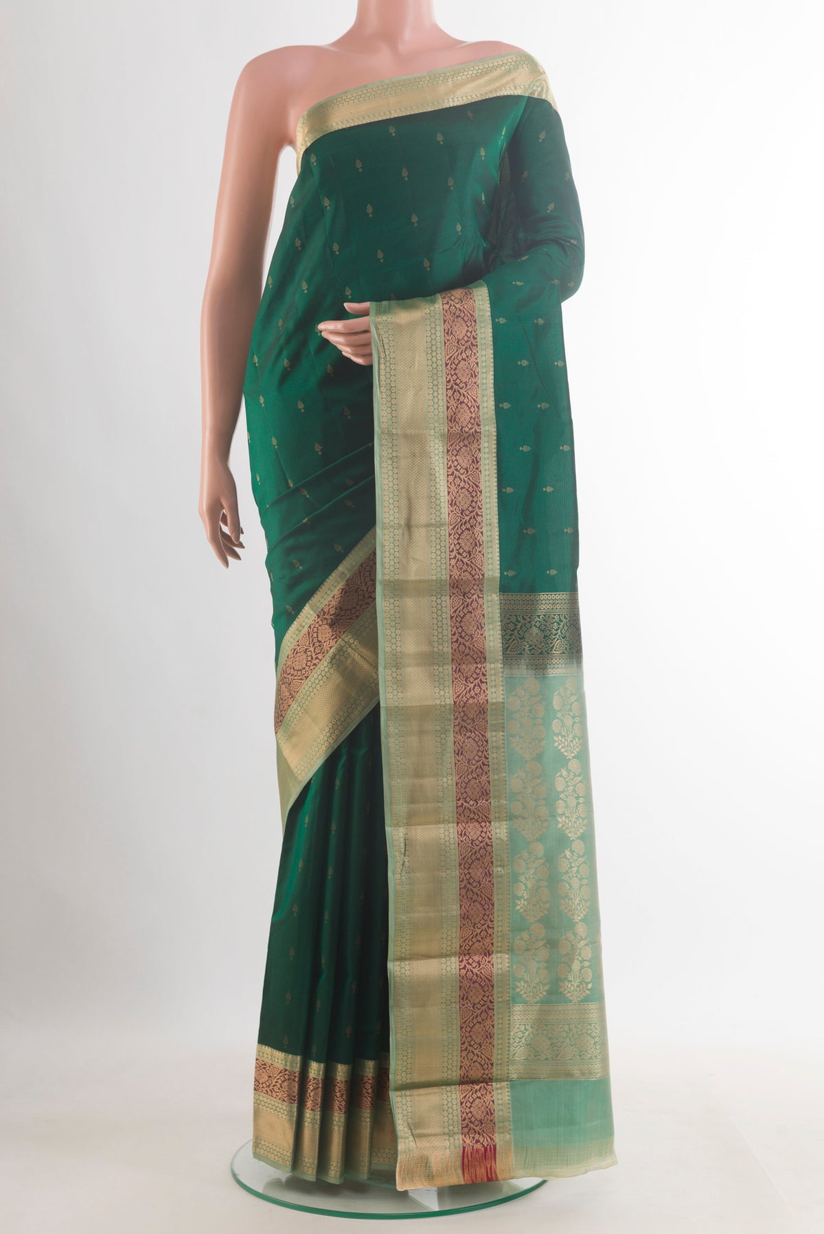 Pure Silk Bottle Green Kanchipuram Saree with Zari Butta on the body and Zari Border.  displayed on a mannequin