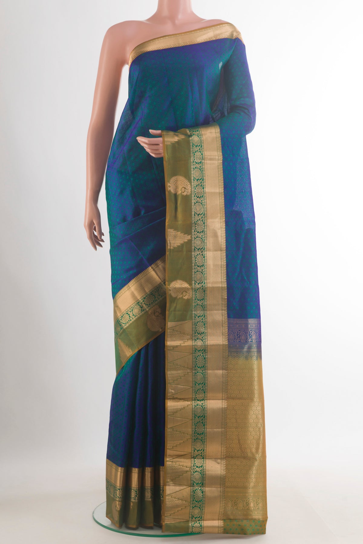 Pure Silk Peacock Blue Kanchipuram Saree with Jacquard design on the body and Zari Border.  displayed on a mannequin