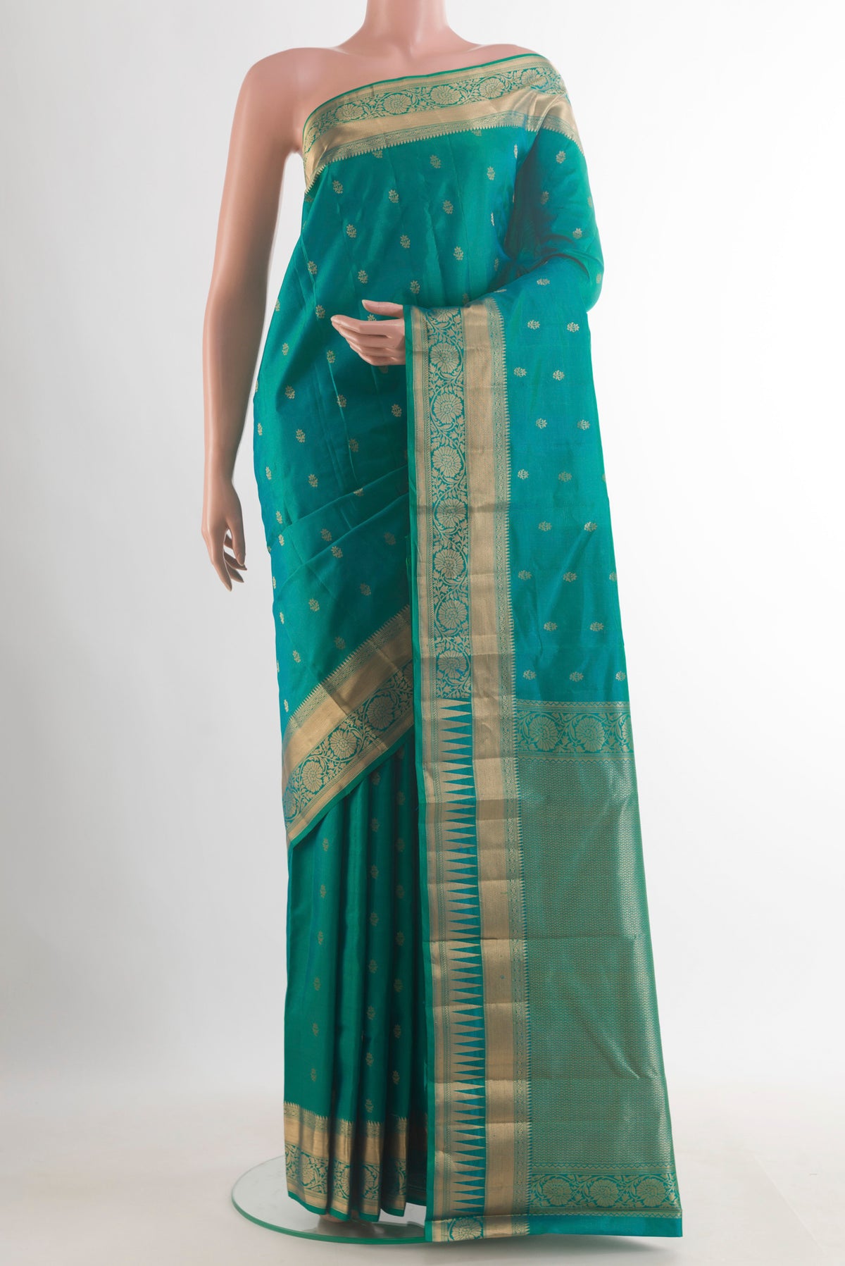 Pure Silk Sea Green Kanchipuram Saree with Zari Butta on the body and Zari Border.  displayed on a mannequin