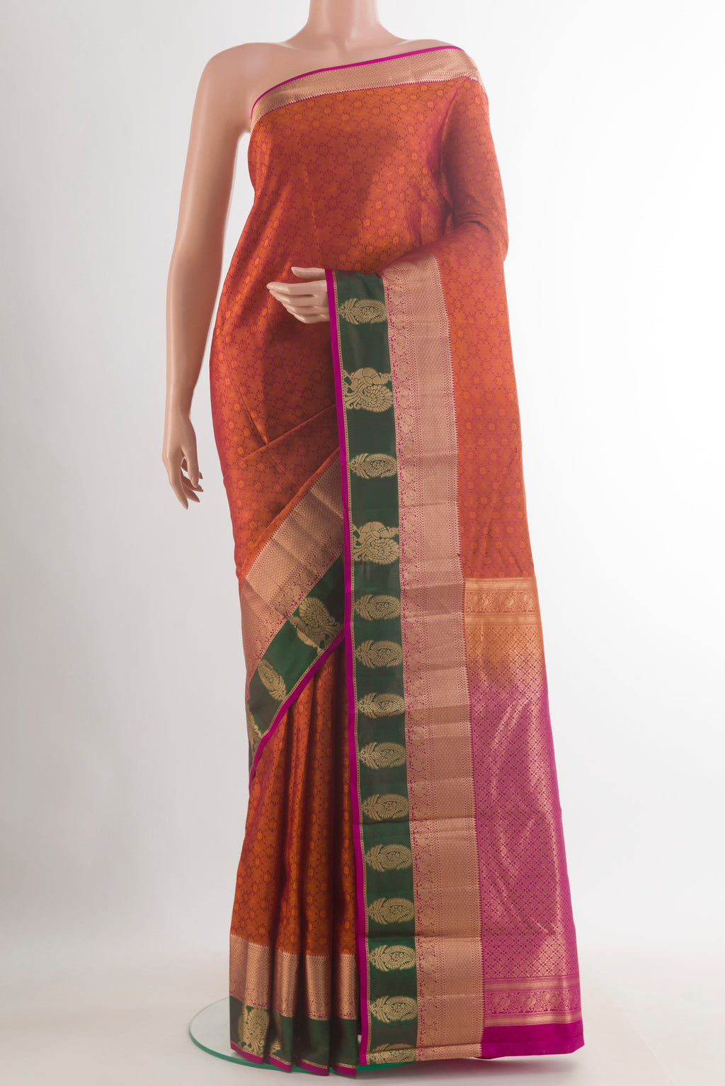 Pure Silk Rust Kanchipuram Saree with Jacquard design on the body and Zari Border.  displayed on a mannequin