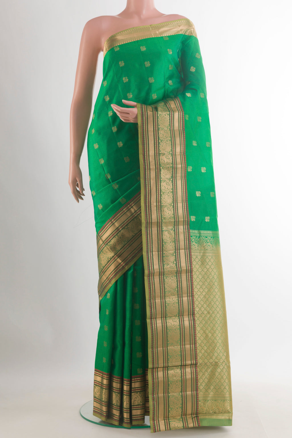 Pure Silk Green Kanchipuram Saree with Zari Butta on the body and Zari Border.  displayed on a mannequin