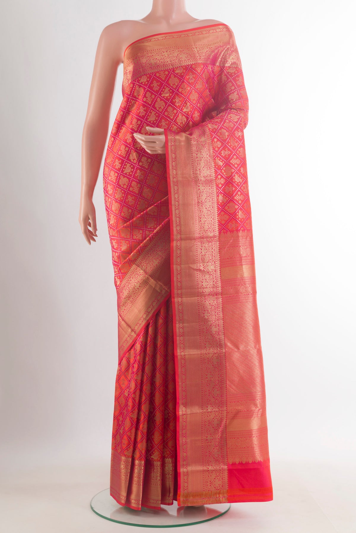Pure Silk Orange Kanchipuram Saree with Zari Brocade on the body and Zari Border.  displayed on a mannequin