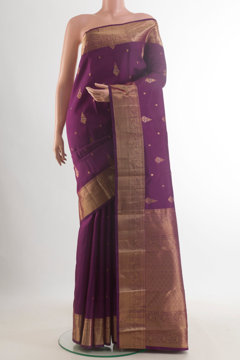 Pure Silk Purple Kanjivaram Saree with Zari Butta on the body and Zari Border.  displayed on a mannequin