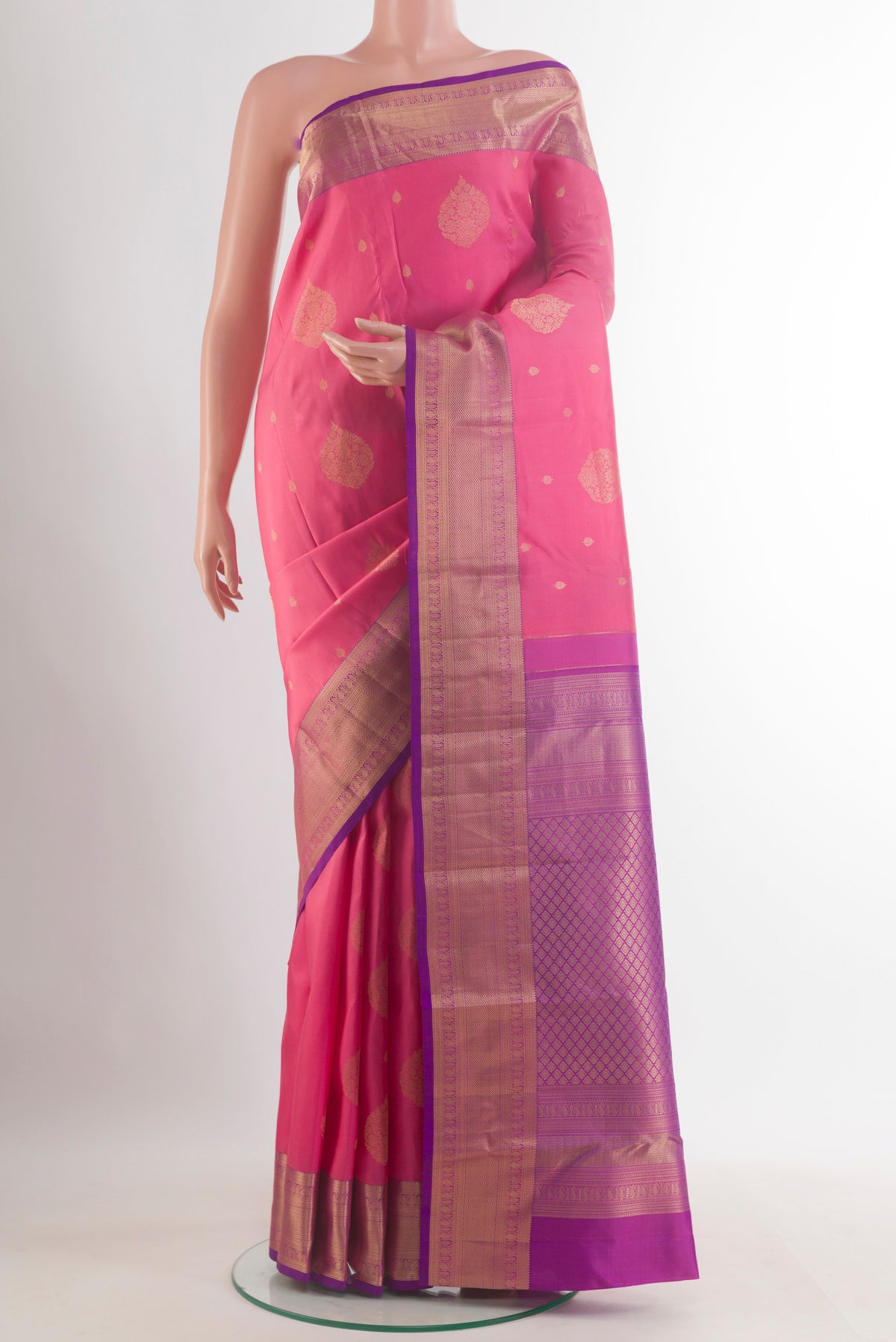 Pure Silk Pink Kanjivaram Saree with Zari Butta on the body and Zari Border.  displayed on a mannequin