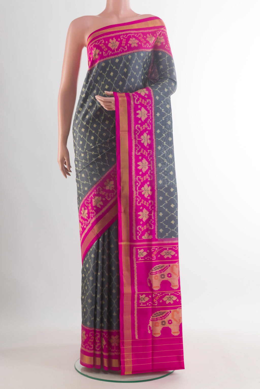 Pure Silk Grey Rajkot Patola Saree with Pure Ikat on the body and Ikat Border.  displayed on a mannequin