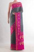 Pure Silk Grey Rajkot Patola Saree with Pure Ikat on the body and Ikat Border.  displayed on a mannequin