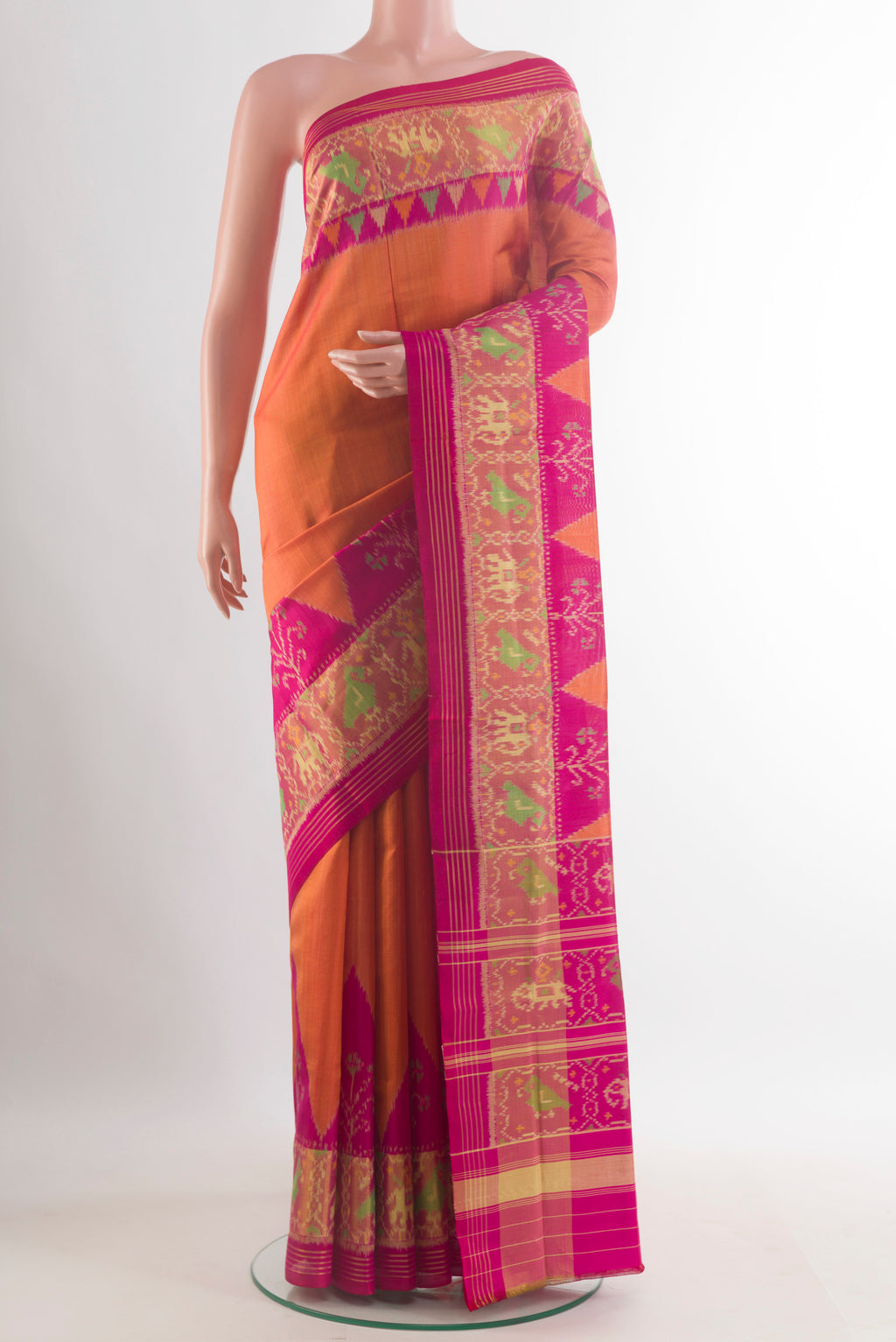 Pure Silk Brick Orange Rajkot Patola Saree with Plain Body and Zari Border.  displayed on a mannequin