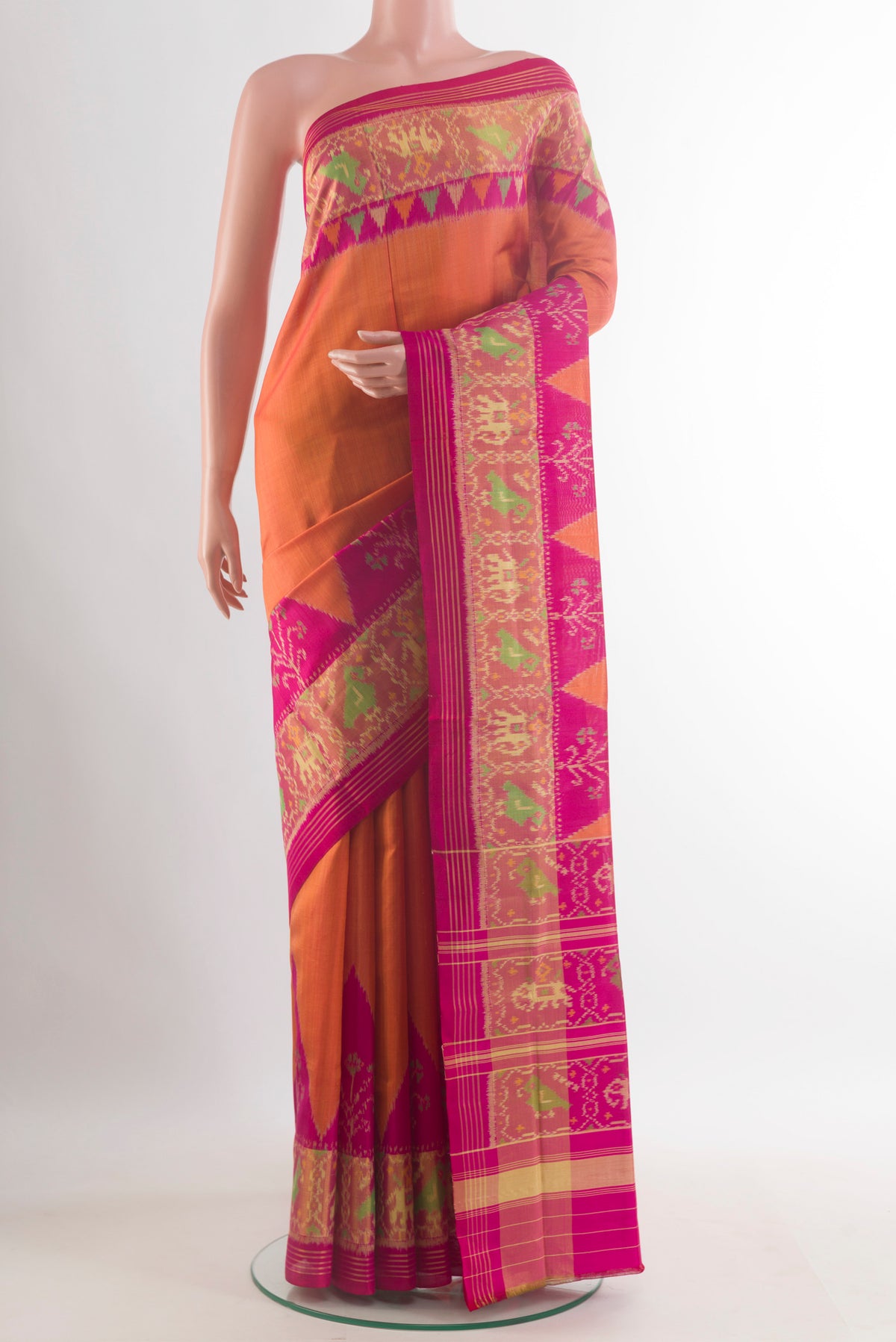 Pure Silk Brick Orange Rajkot Patola Saree with Plain Body and Zari Border.  displayed on a mannequin