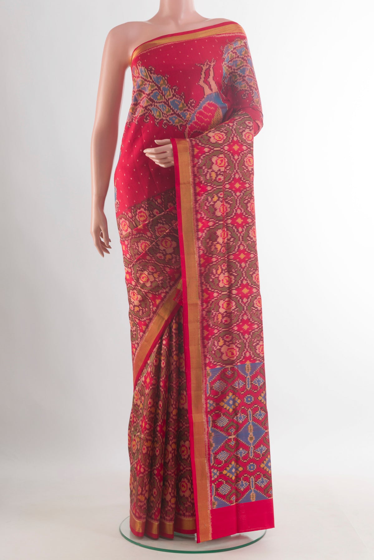 Pure Silk Red Rajkot Patola Saree with Pure Ikat on the body and Zari Border.  displayed on a mannequin