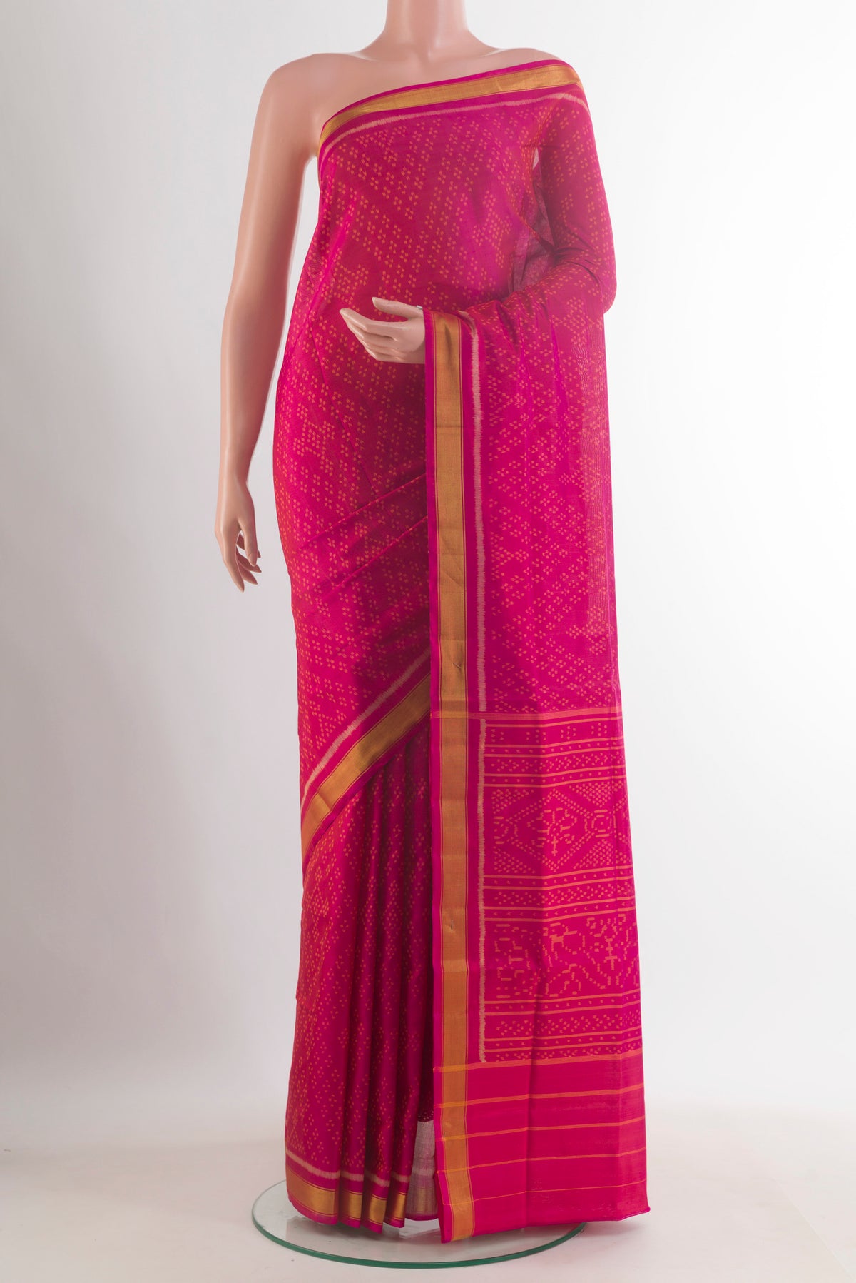 Pure Silk Pink Rajkot Patola Saree with Pure Ikat on the body and Zari Border.  displayed on a mannequin