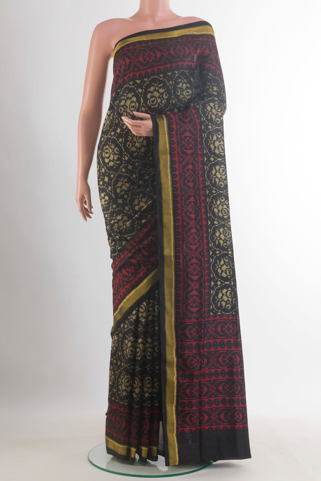 Pure Silk Black Rajkot Patola Saree with Pure Ikat on the body and Zari Border.  displayed on a mannequin
