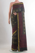 Pure Silk Black Rajkot Patola Saree with Pure Ikat on the body and Zari Border.  displayed on a mannequin