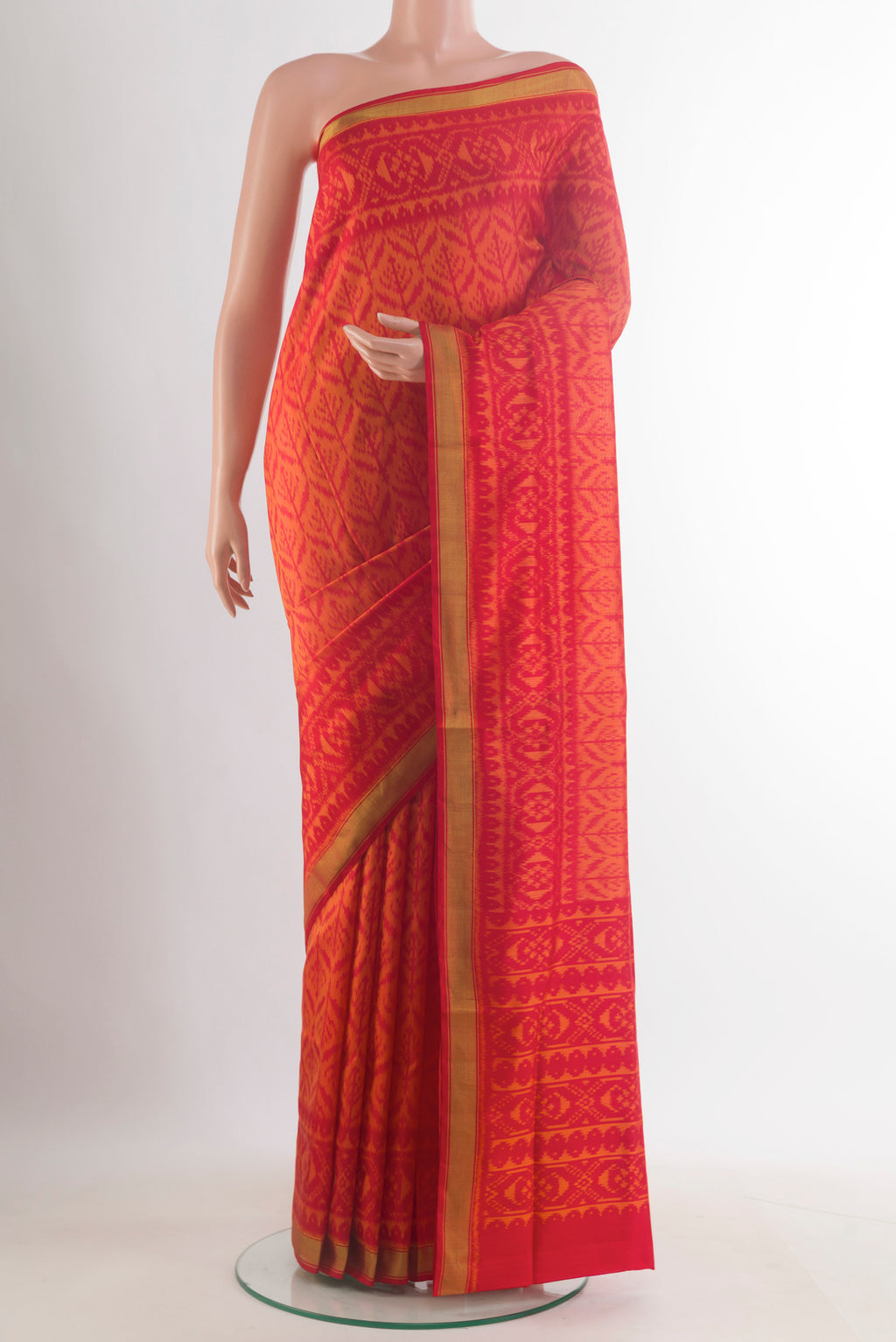 Pure Silk Orange Rajkot Patola Saree with Pure Ikat on the body and Ikat Border.  displayed on a mannequin