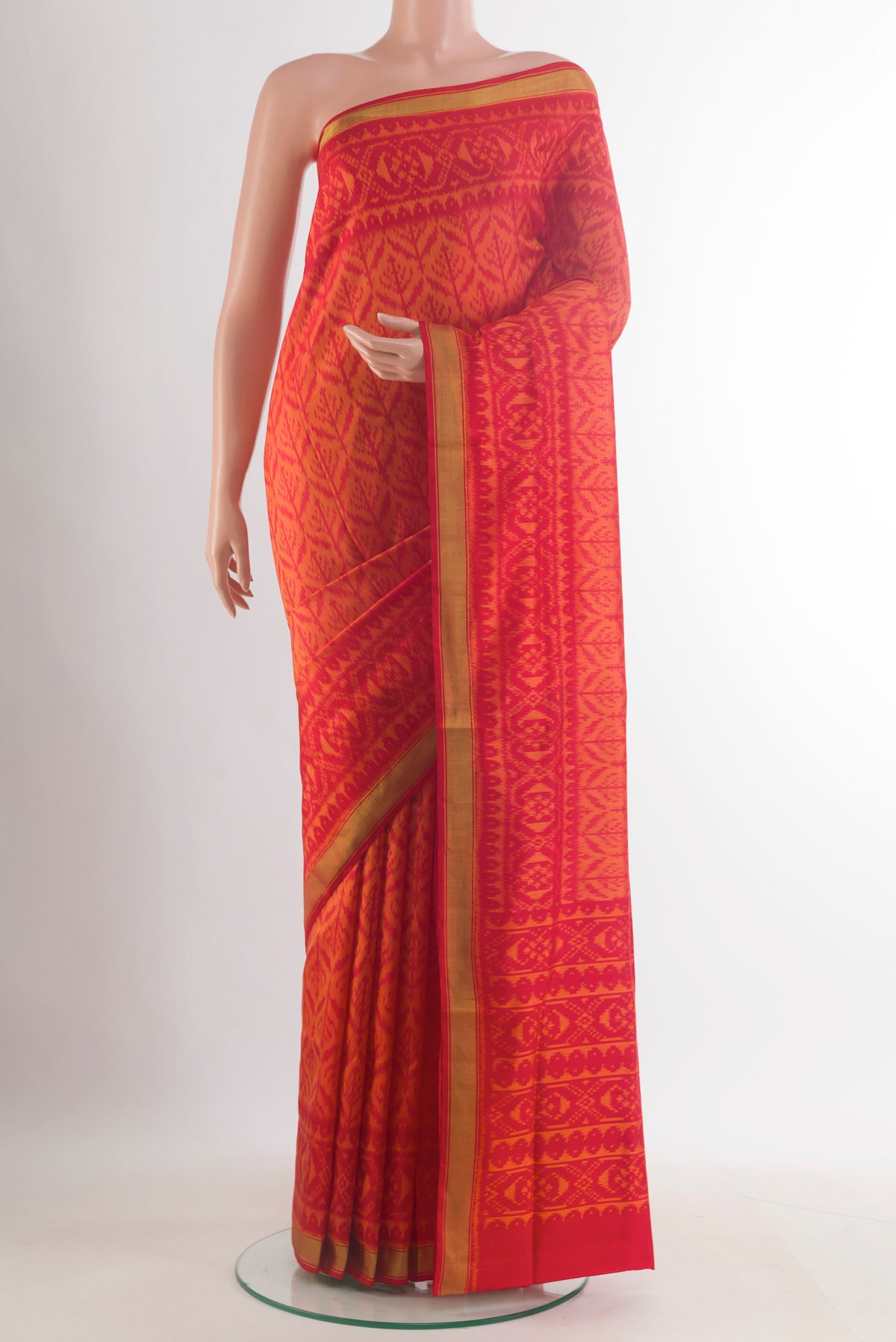 Pure Silk Orange Rajkot Patola Saree with Pure Ikat on the body and Ikat Border.  displayed on a mannequin