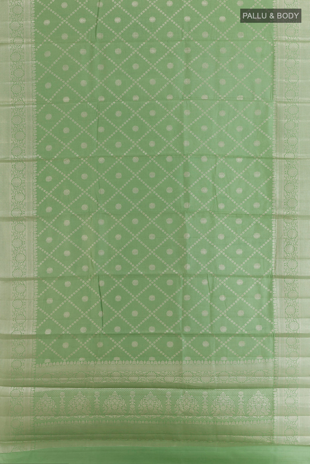 Flat view of Green Tussar Saree with Zari Brocade on the body and Zari Border. 