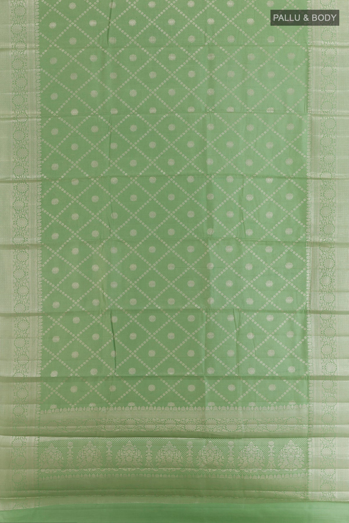 Flat view of Green Tussar Saree with Zari Brocade on the body and Zari Border. 