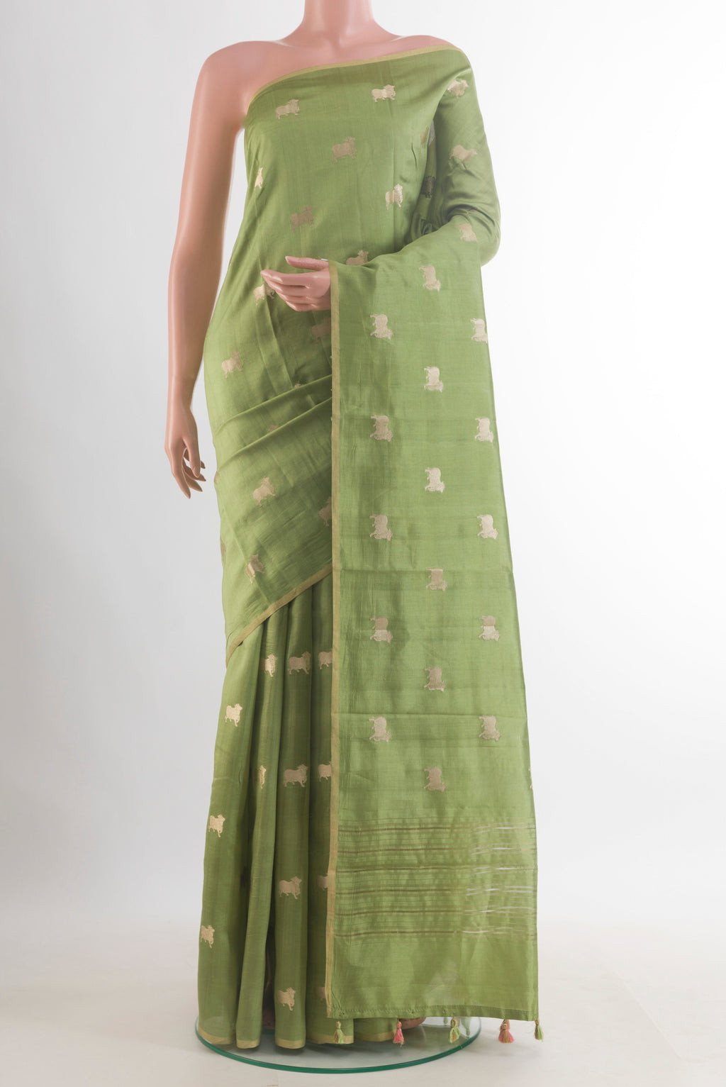 Green Tussar Saree with Zari Butta on the body and Without Border.  displayed on a mannequin