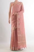 Peach Tussar Saree with Zari Butta on the body and Zari Border.  displayed on a mannequin