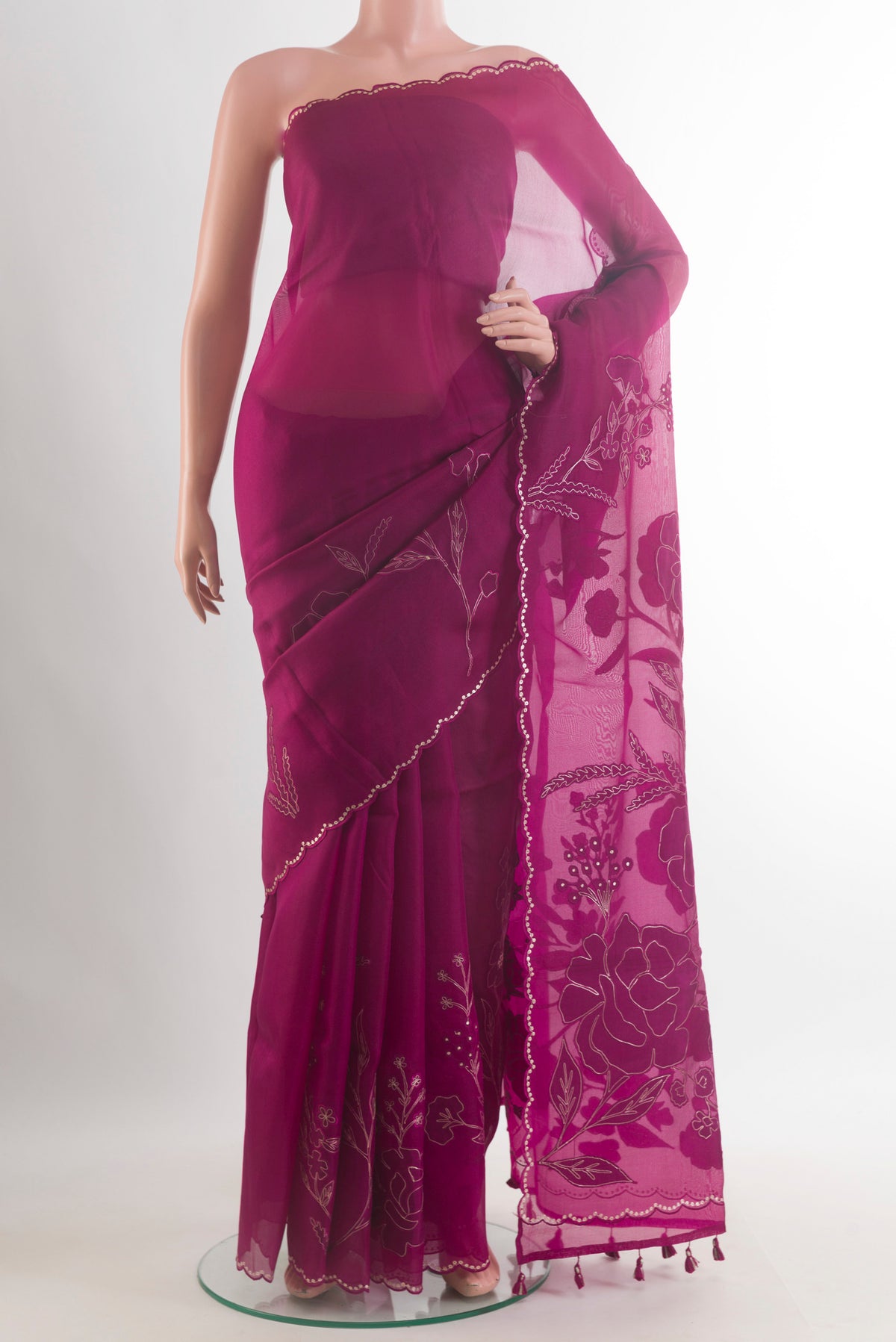 Magenta Organza Saree with Embroidered on the body and Embroidered Border.  displayed on a mannequin