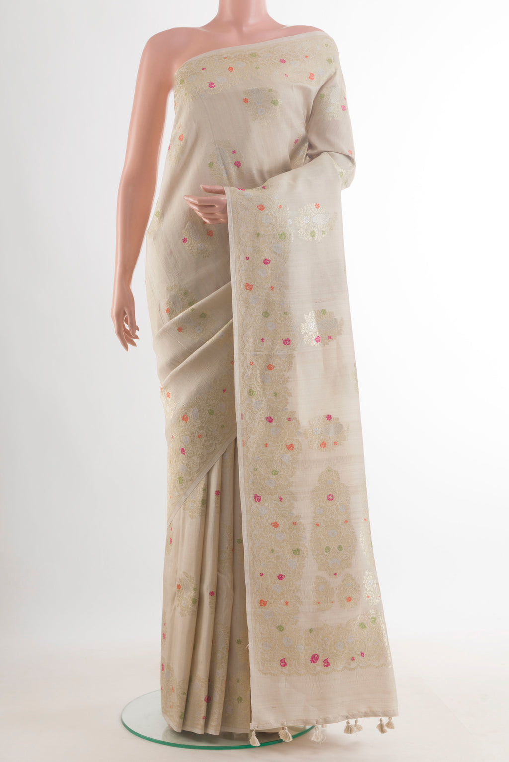 Off White Banarasi Tussar Saree with Zari Butta on the body and Zari Border.  displayed on a mannequin