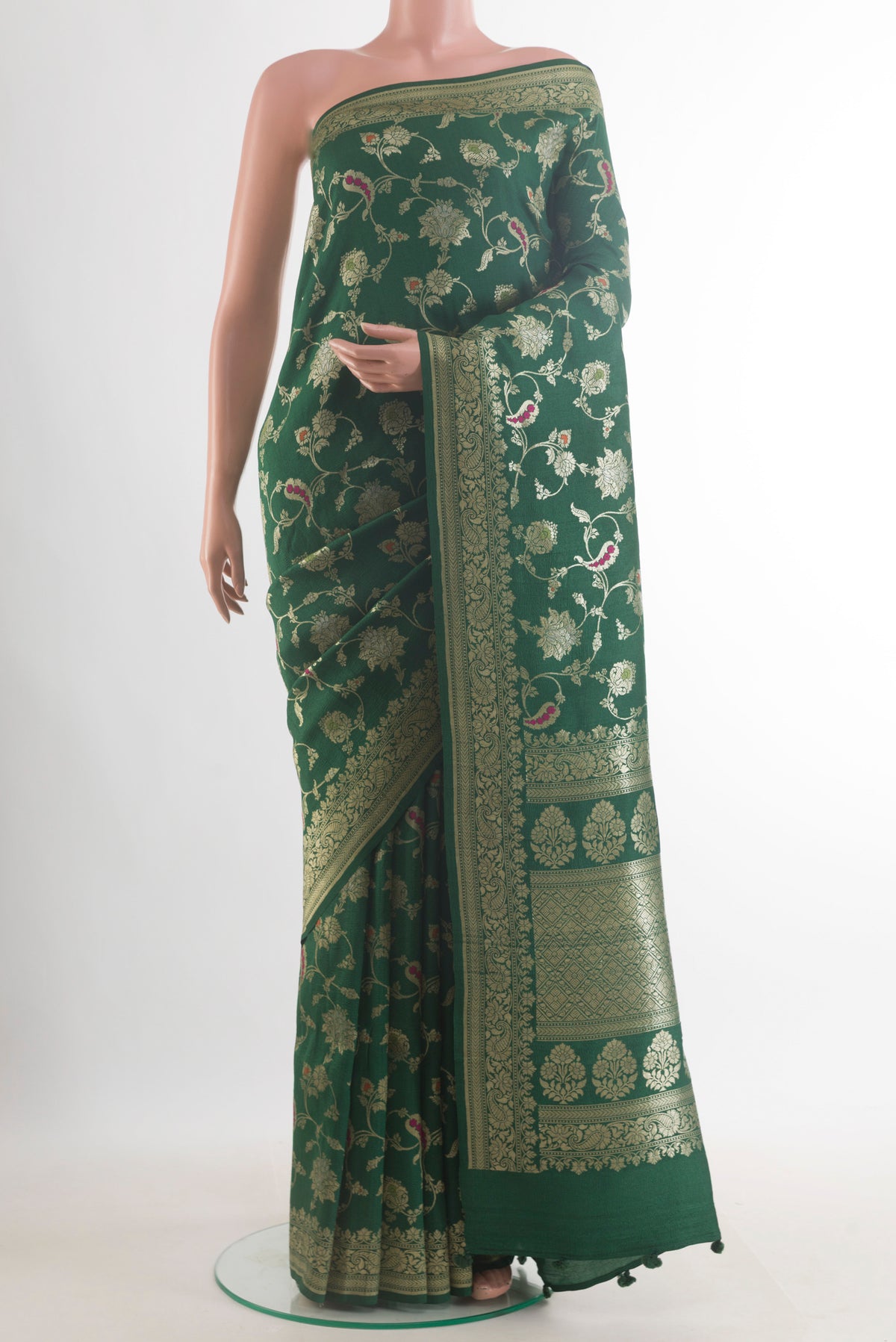 Bottle Green Banarasi Tussar Saree with Zari Brocade on the body and Zari Border.  displayed on a mannequin