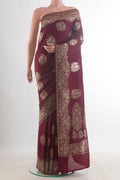 Maroon Banarasi Tussar Saree with Zari Butta on the body and Zari Border.  displayed on a mannequin