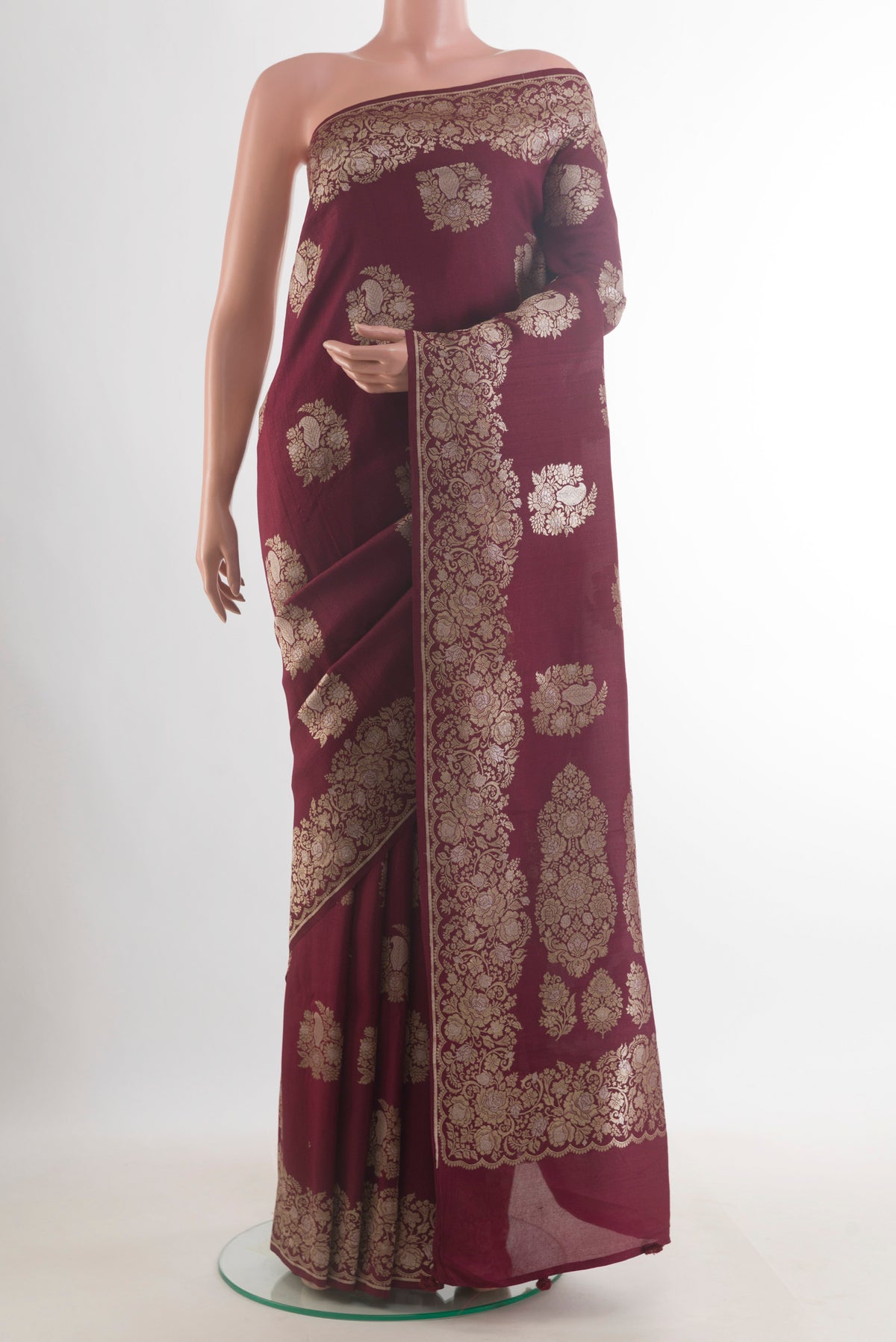 Maroon Banarasi Tussar Saree with Zari Butta on the body and Zari Border.  displayed on a mannequin