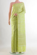 Light Green Tussar Saree with Zari Brocade on the body and Zari Border.  displayed on a mannequin