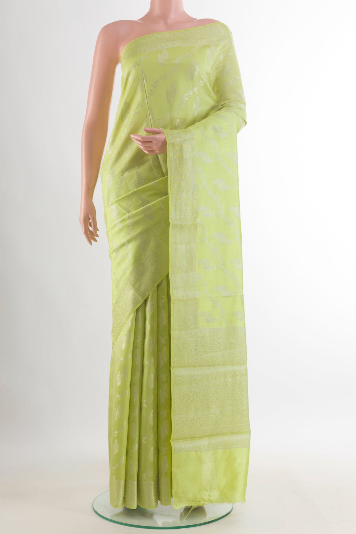 Light Green Tussar Saree with Zari Brocade on the body and Zari Border.  displayed on a mannequin