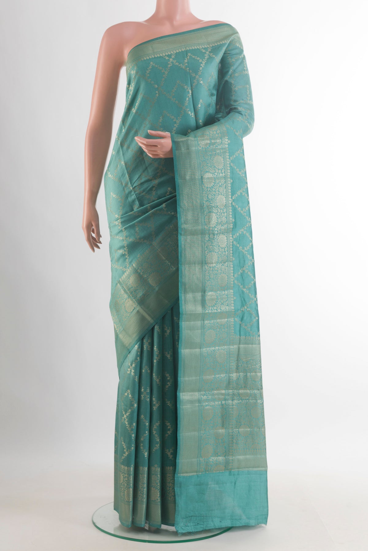 Turquoise Tussar Saree with Zari Brocade on the body and Zari Border.  displayed on a mannequin