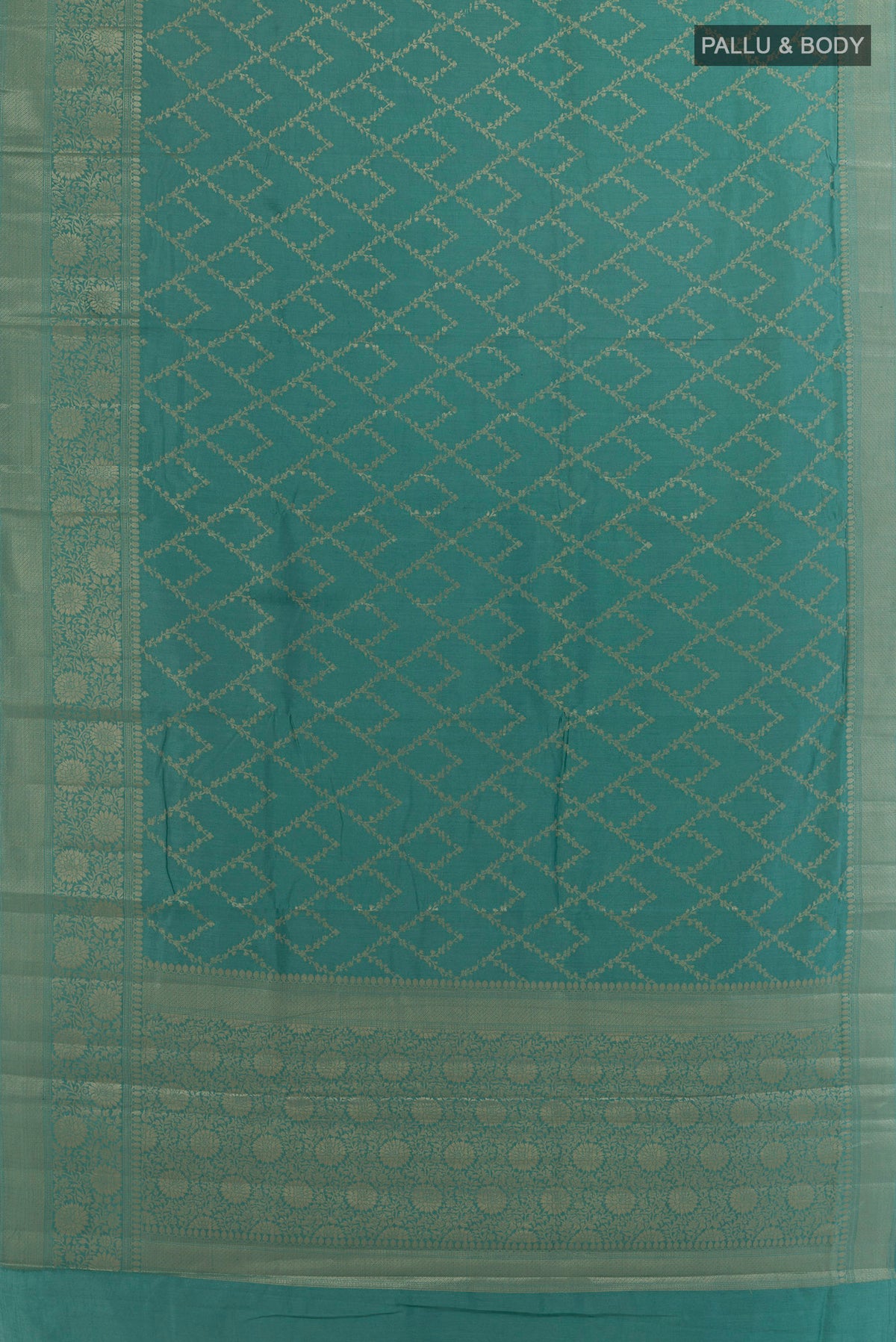 Flat view of Turquoise Tussar Saree with Zari Brocade on the body and Zari Border. 