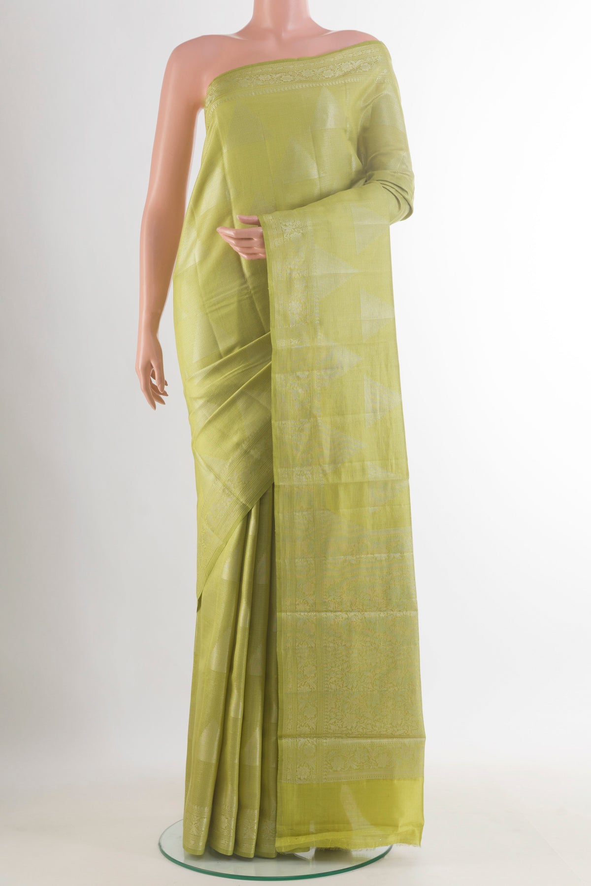 Green Tussar Saree with Zari Butta on the body and Zari Border.  displayed on a mannequin