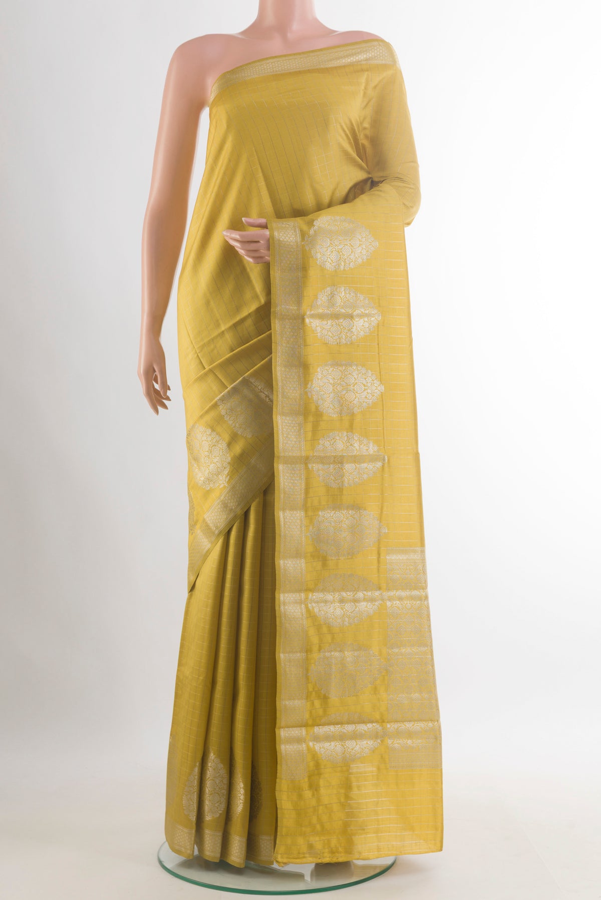 Mustard Tussar Saree with Checked design on the body and Zari Border.  displayed on a mannequin