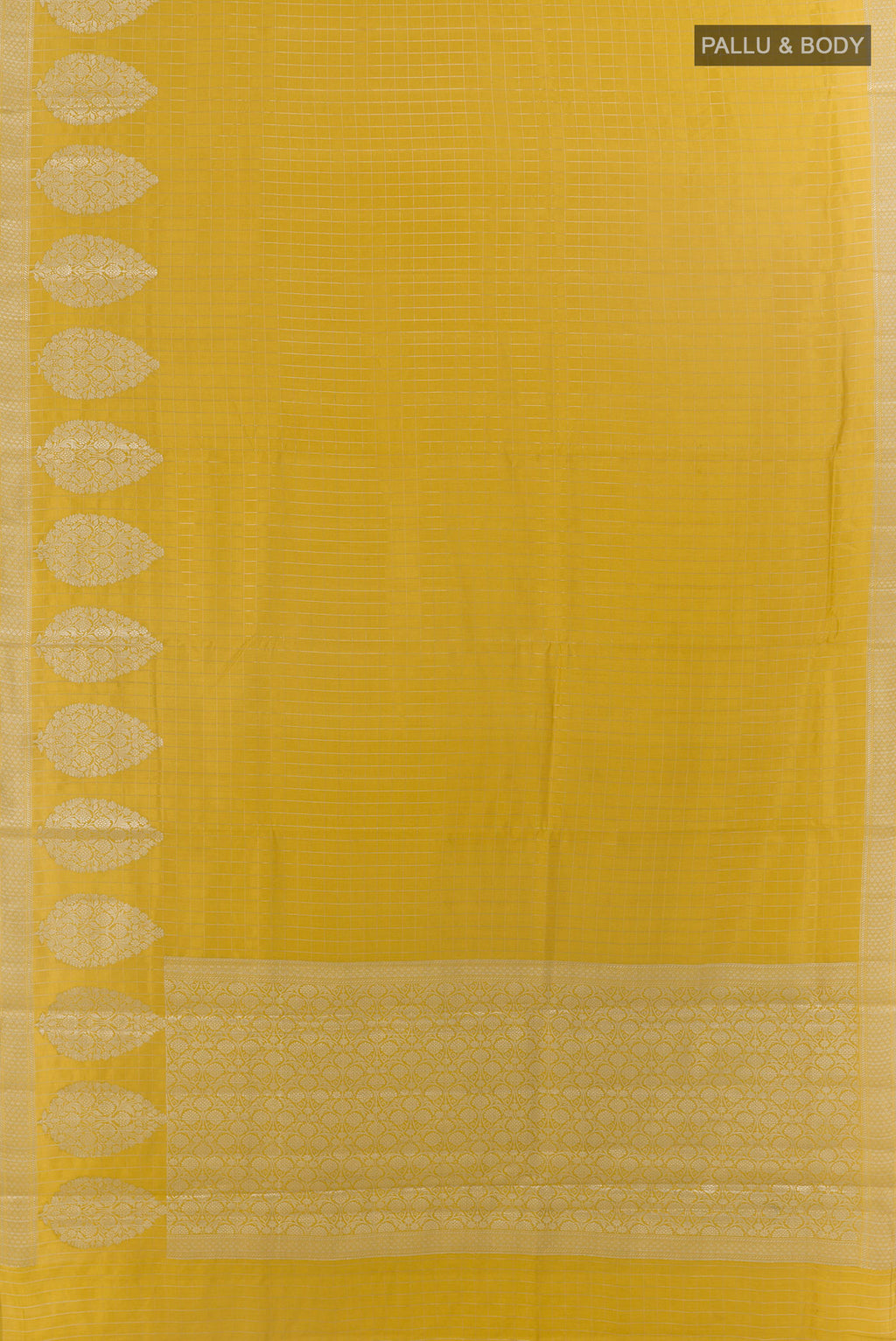 Flat view of Mustard Tussar Saree with Checked design on the body and Zari Border. 